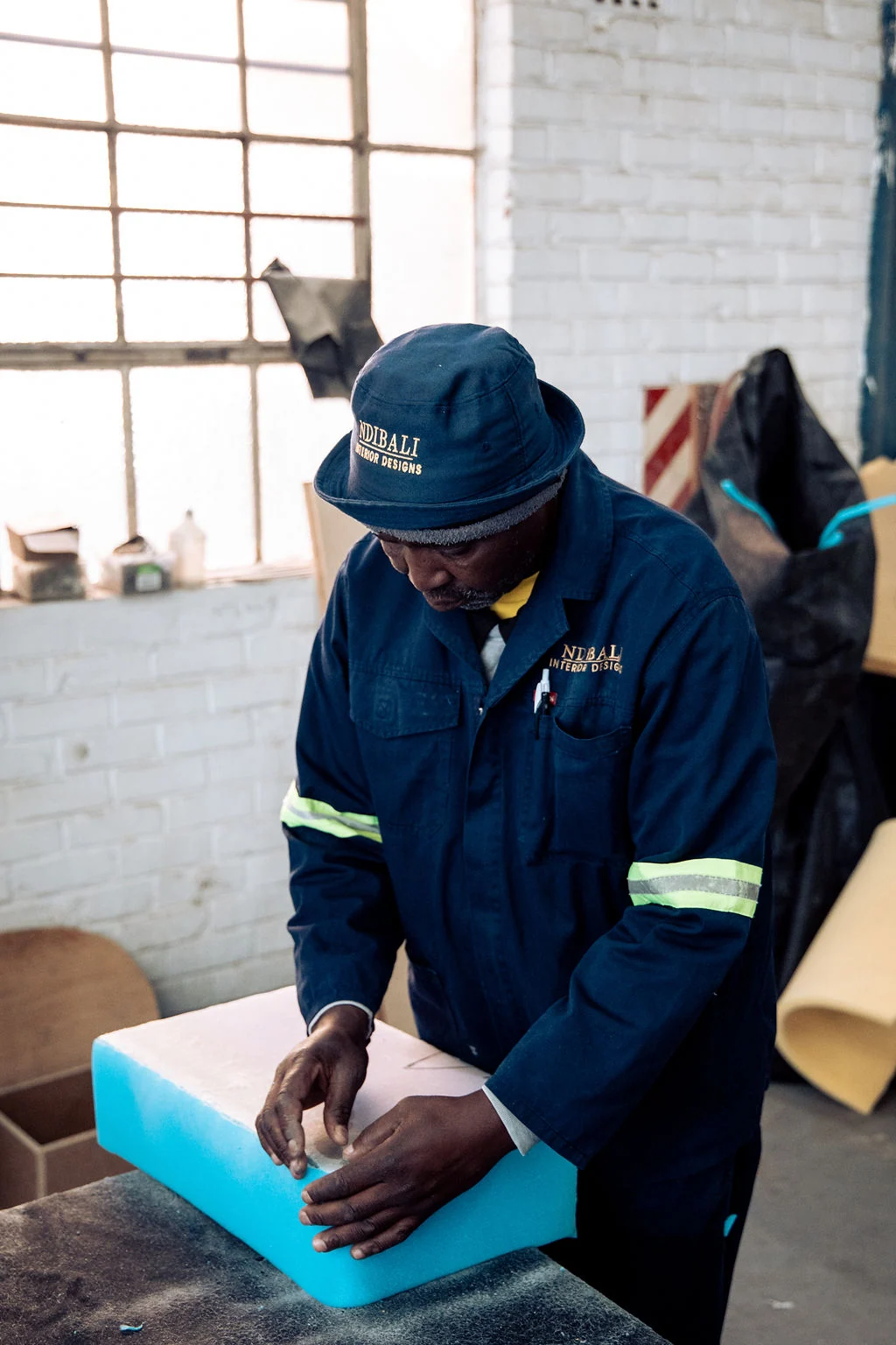 Ndibali craftsperson working on custom joinery